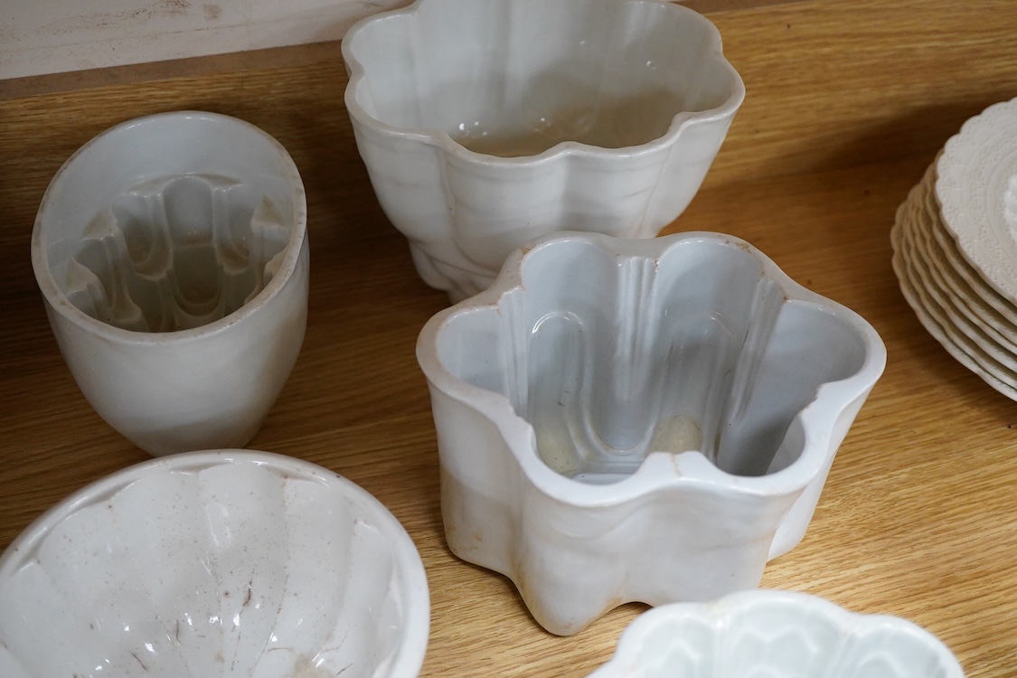 A collection of fifteen mostly 20th century ceramic jelly moulds, largest 16cm high